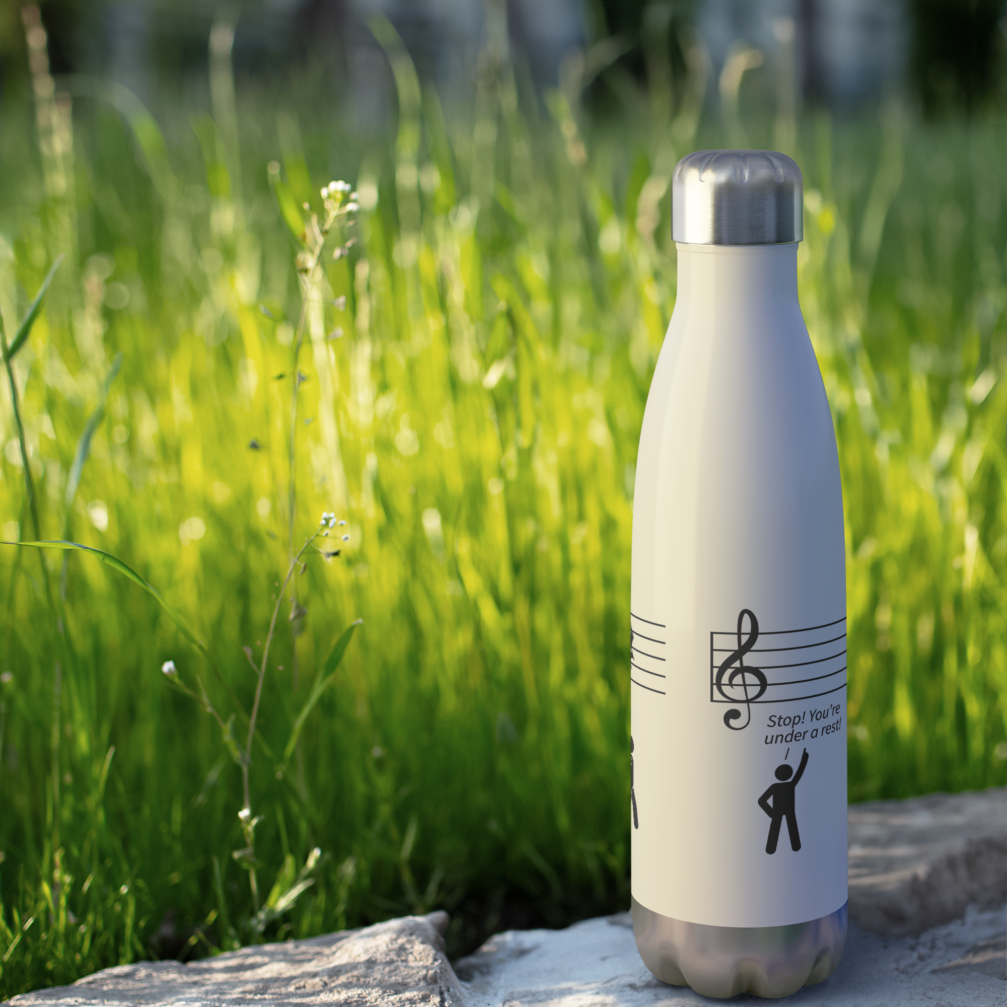 Under_Rest_Water_Bottle_20_oz_WaterBottle_Outdoor_grass_Mockup.png